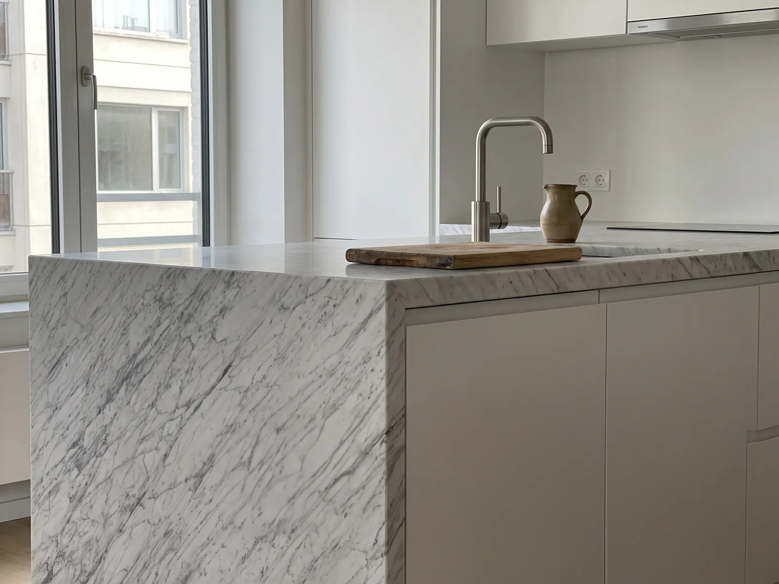 Kitchen with a Carrara marble countertop and backsplash