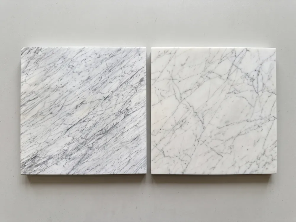 Two nearly identical samples of white marble with gray veining, side by side