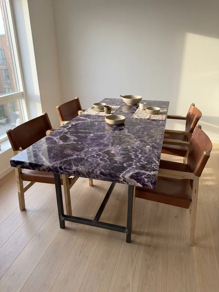 Dining table with an amethyst top on a steel base: dark violet crystals with white and lilac zigzag bands