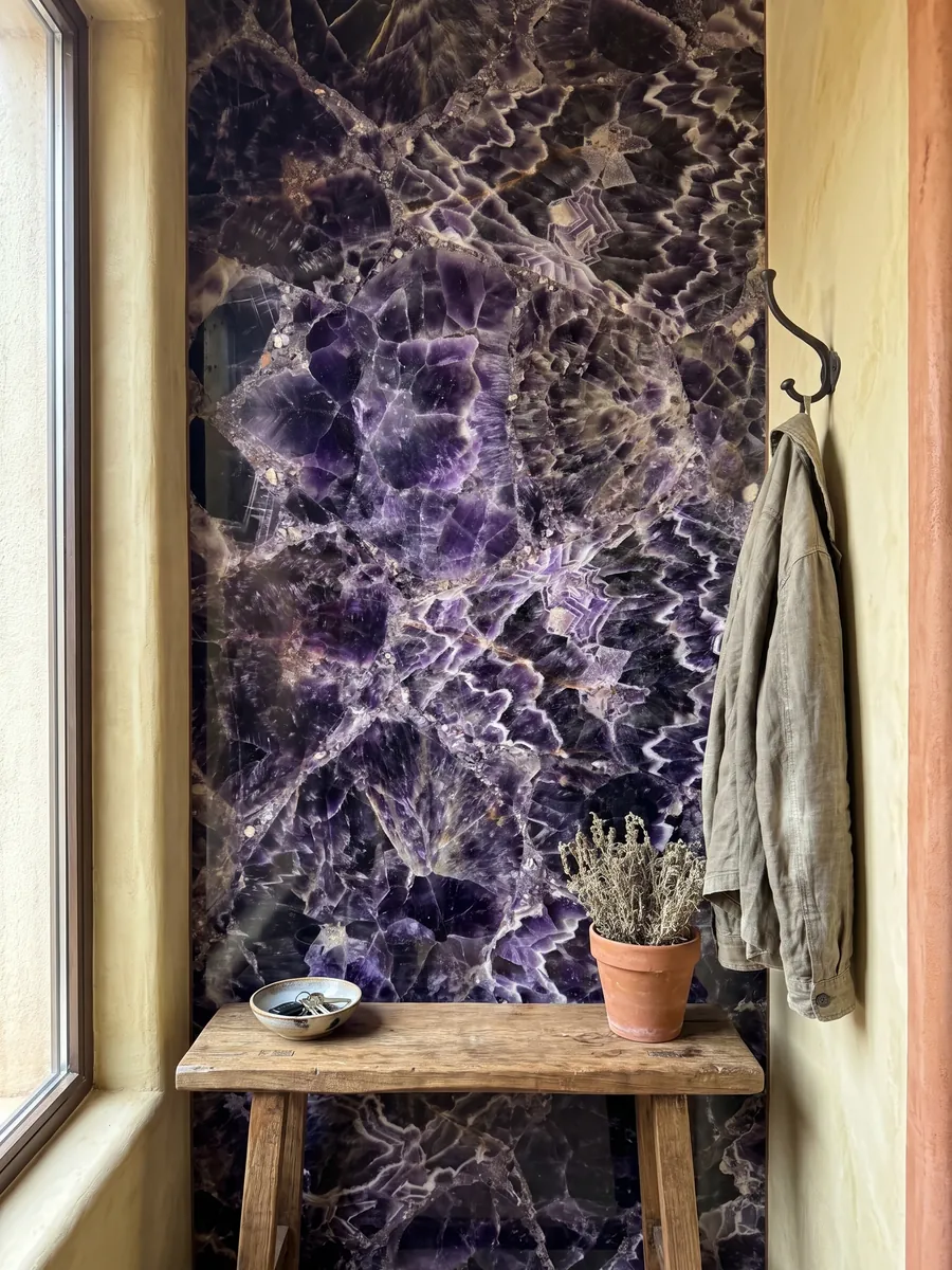 Entryway wall clad in amethyst with a narrow console: dark violet crystals with white and lilac zigzag bands
