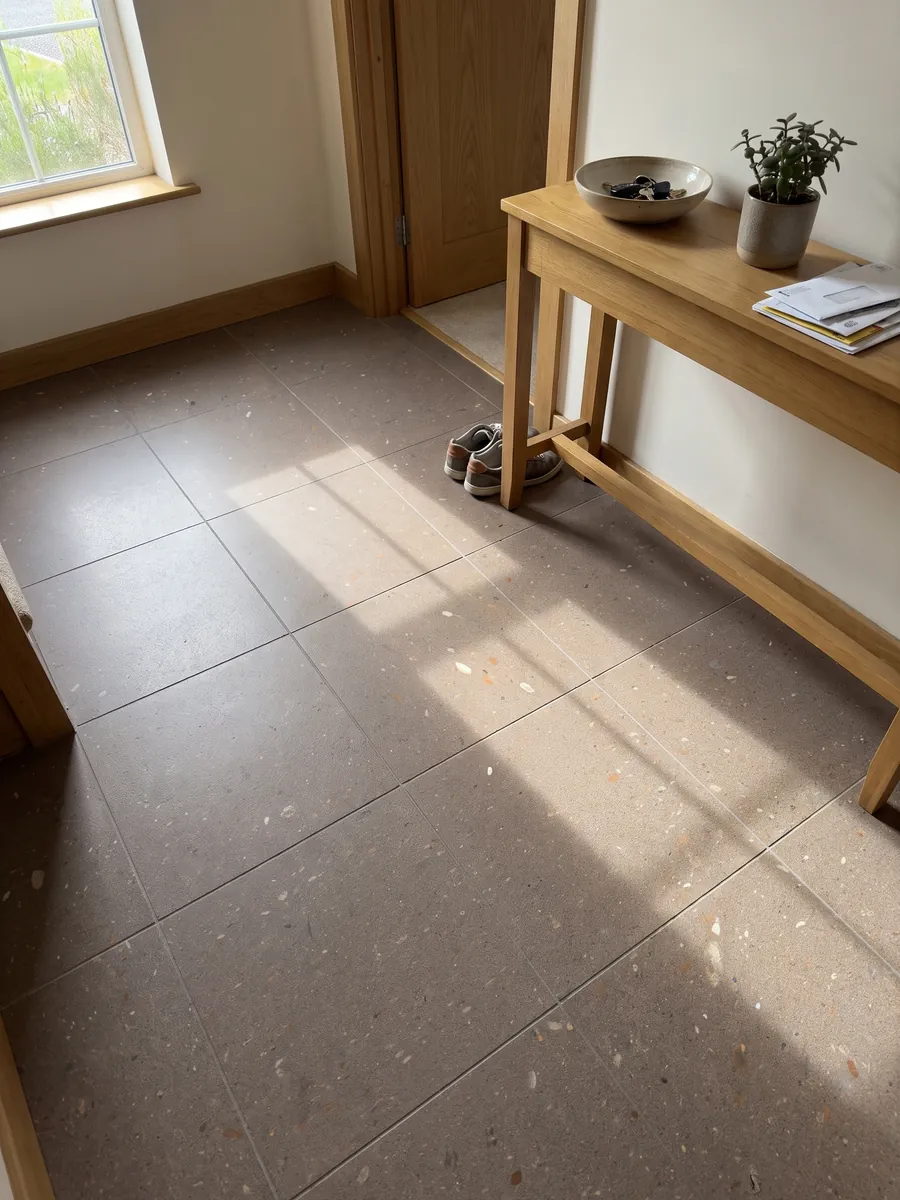 Entryway floor in large Lavarosa basalt slabs with natural light: pinkish taupe, fine grained, with small white and reddish inclusions