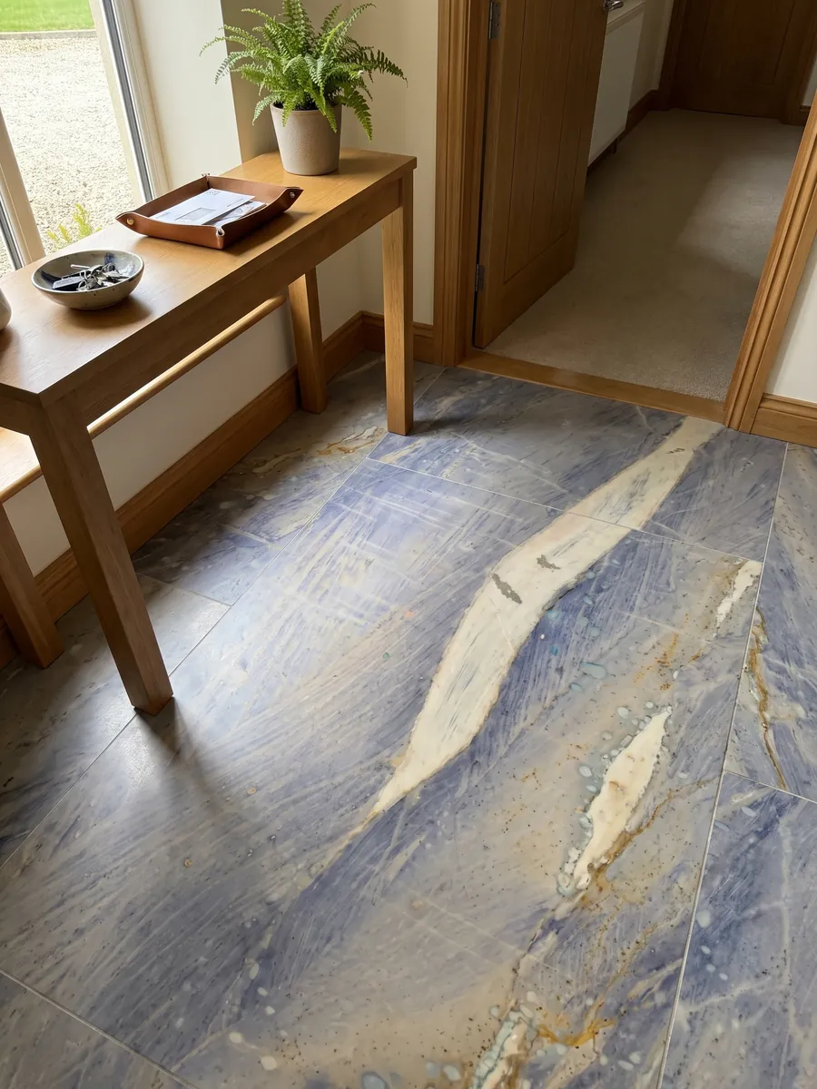 Entryway floor in large Azul Macaubas quartzite slabs with natural light: lavender blue background with a large cream band on the diagonal and ochre touches