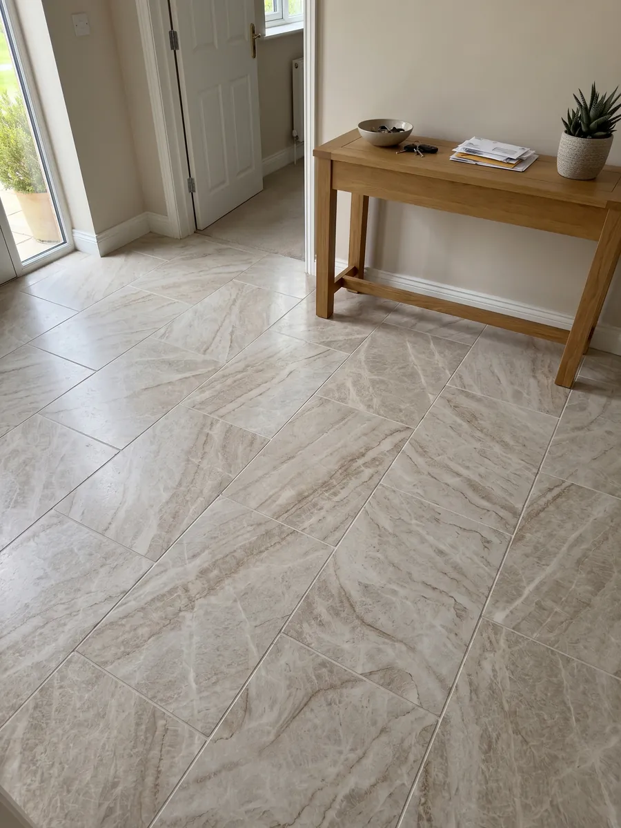 Entryway floor in large slabs of beige Taj Mahal quartzite with natural light: light beige with soft caramel veins in a diagonal