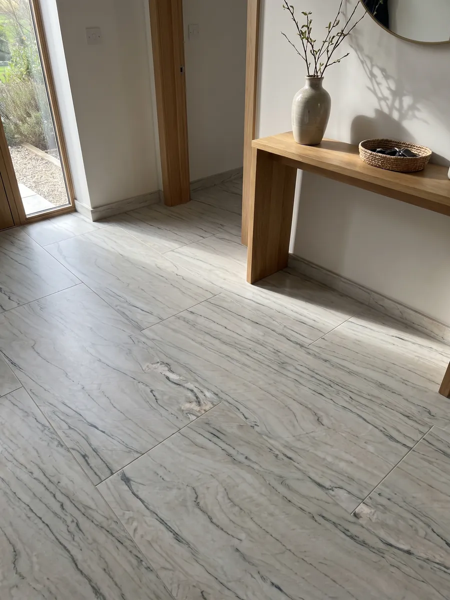 Entryway floor in large slabs of white Macaubas Fantasy quartzite with natural light: creamy white with fine horizontal gray-green lines
