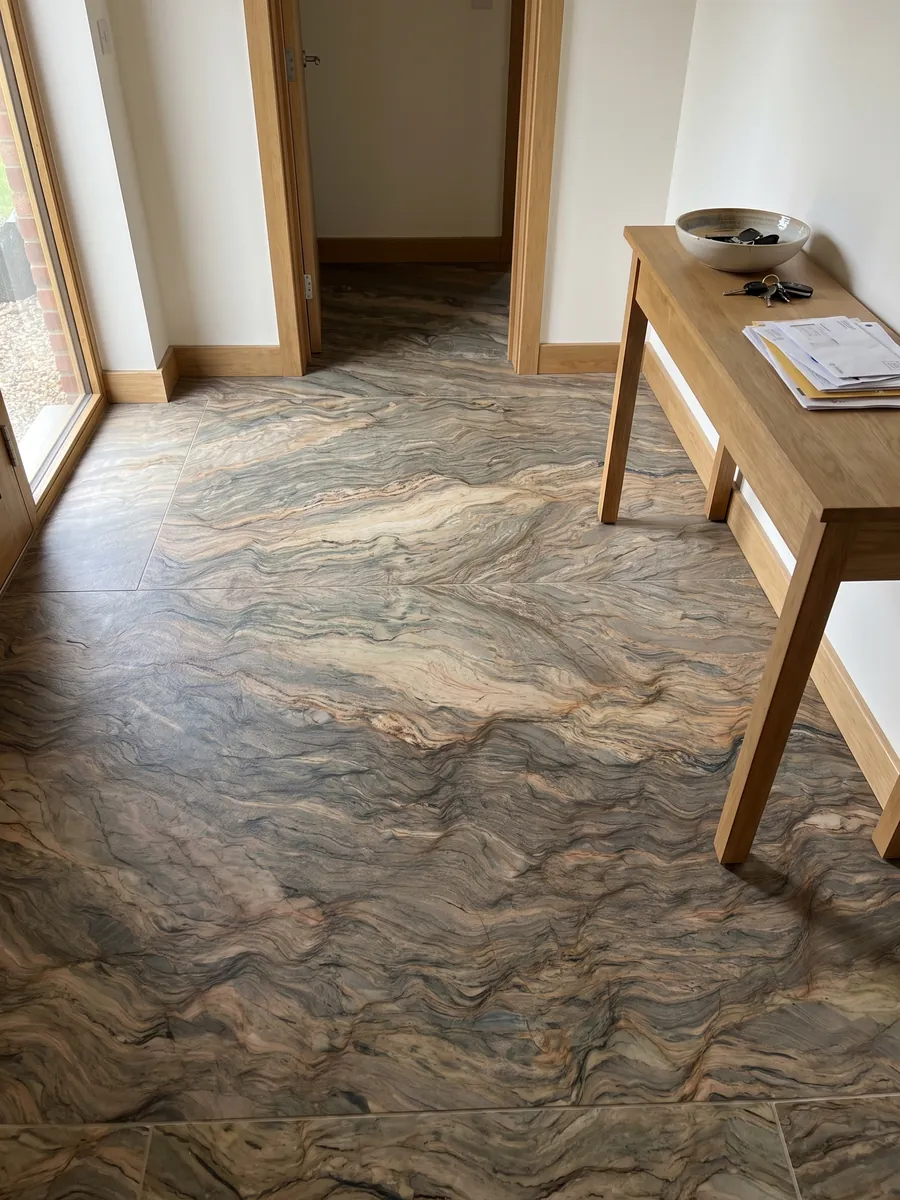 Entryway floor in large slabs of brown Fusion quartzite with natural light: horizontal waves in ocher and greenish gray, like layers of earth