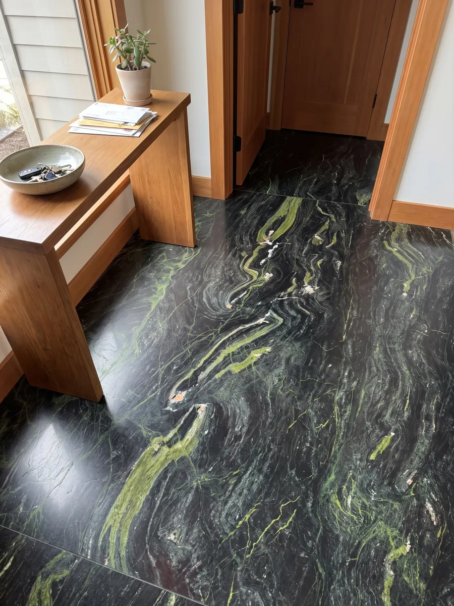 Entryway floor in large slabs of Vancouver black quartzite with natural light: greenish black with horizontal lime green waves