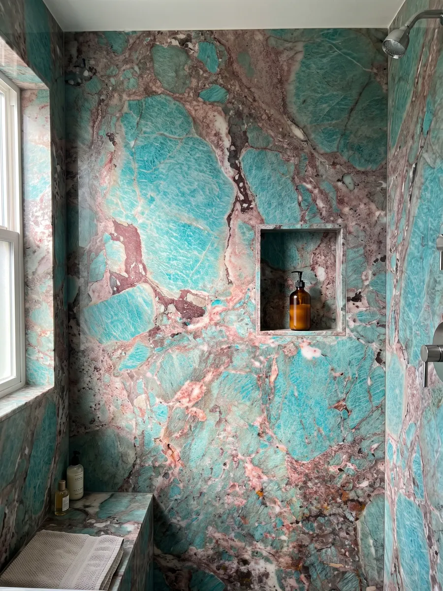 Shower clad in full green Amazzonite quartzite slabs with a recessed niche: intense turquoise patches surrounded by pink and burgundy areas