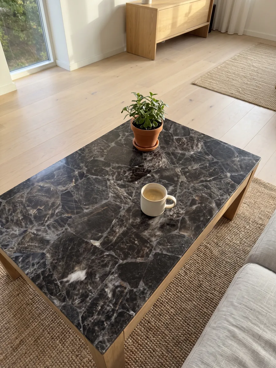 Coffee table with a smoky quartz top in a living room: dark gray, almost black fragments bounded by light edges and lines