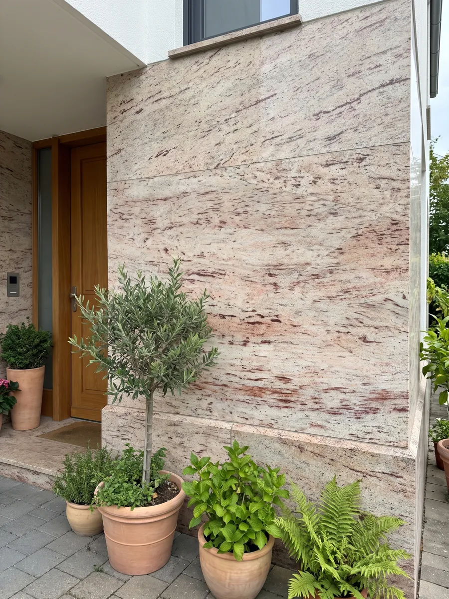 House facade clad in Ivory Brown beige granite next to a wood door: ivory with reddish and burgundy horizontal strokes