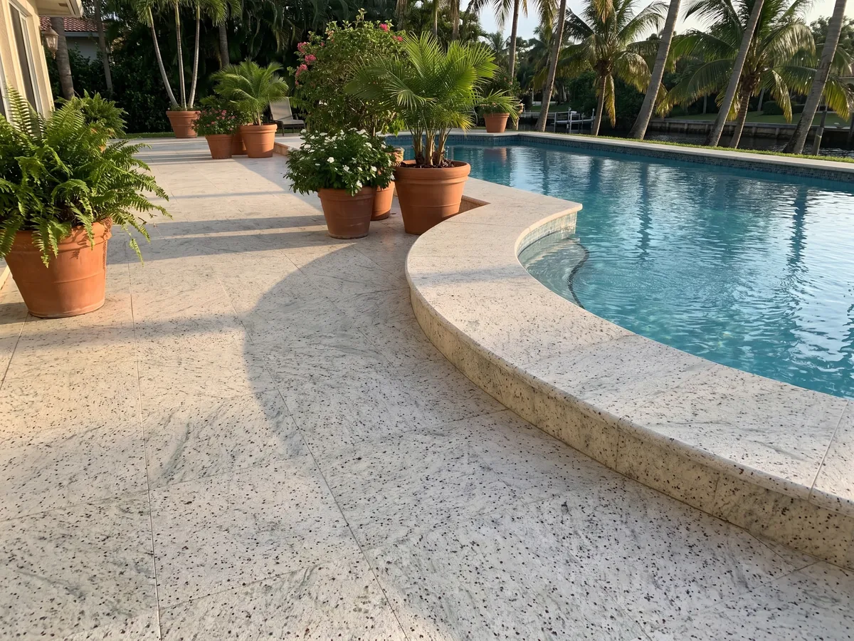 Terrace floor and pool coping in Kashmir White granite with planters: ivory white with garnet dots and soft greenish-gray clouds