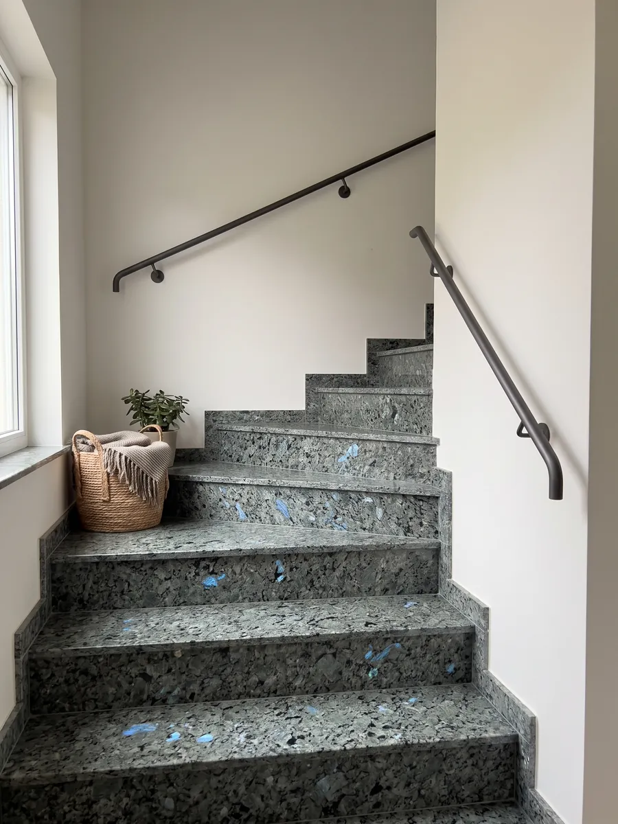 Interior staircase with Labradorite granite treads and a handrail: large greenish-gray crystals with iridescent blue flashes