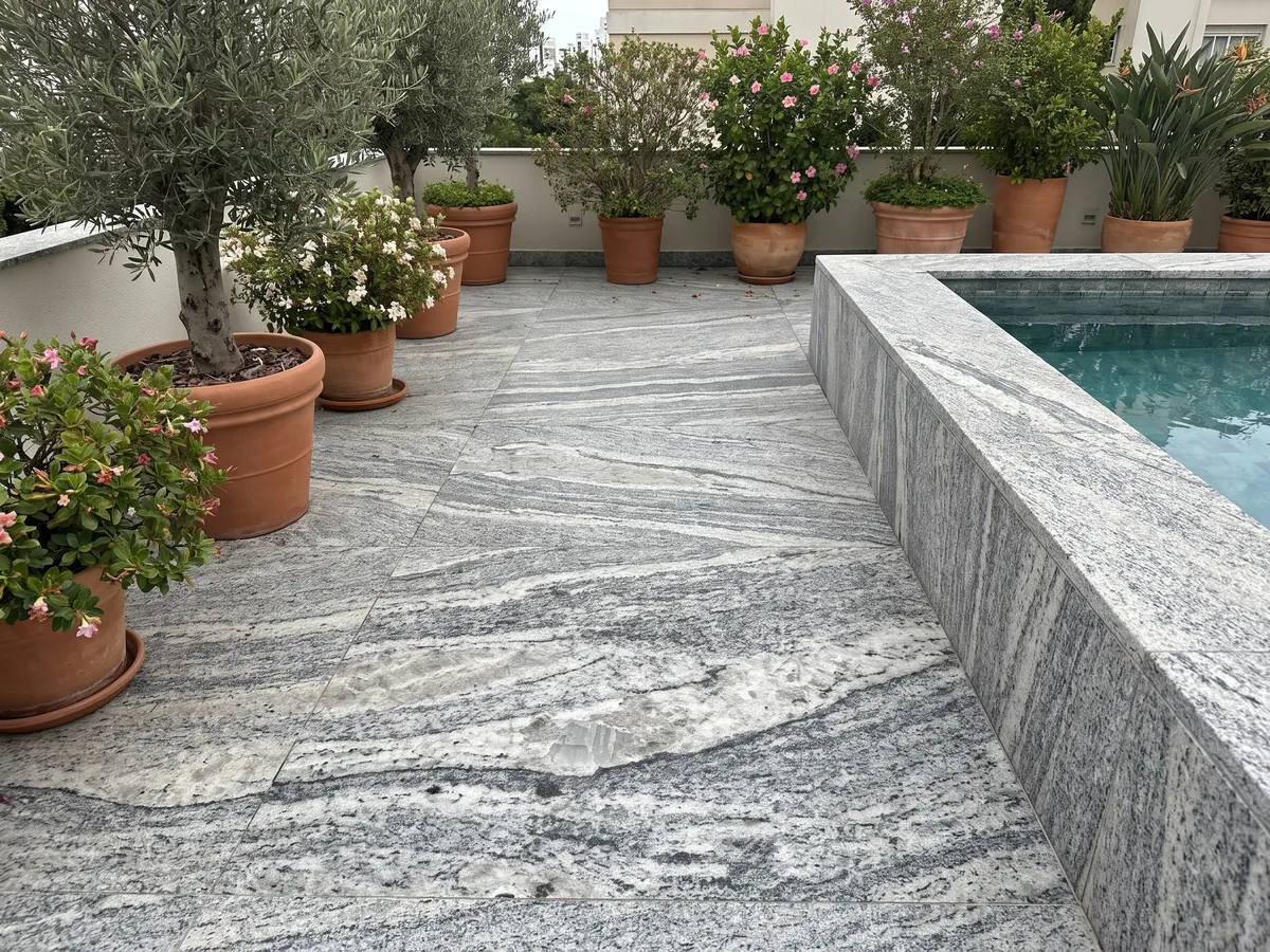 Terrace floor and pool coping in Piracema White gray granite with planters: wavy gray and white bands with one large light fragment