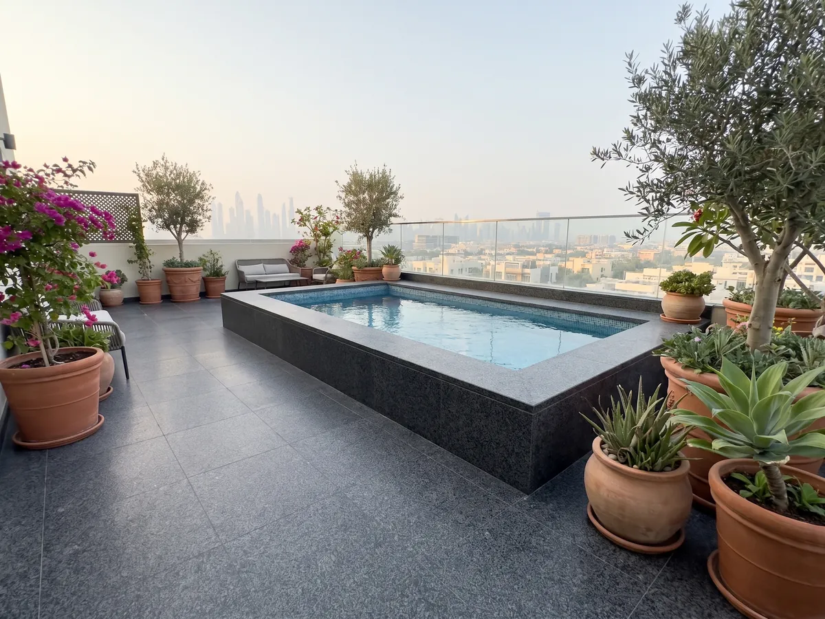 Terrace floor and pool coping in Nero Africa black granite with planters: uniform fine-grained black with a light gray speckle