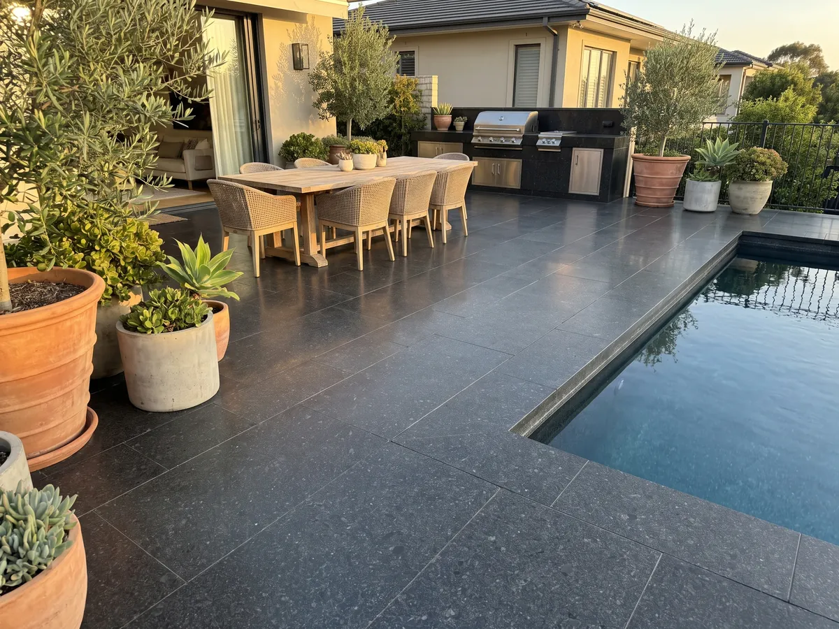 Terrace floor and pool coping in Negro San Gabriel granite with planters: deep black with a medium grain and dark gray specks that show up close