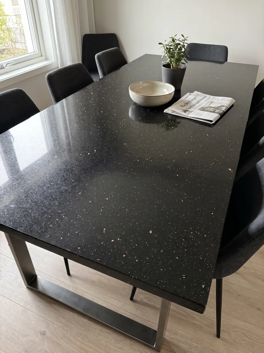 Dining table with a black Star Galaxy granite top on a steel base: black with small shining gold flecks