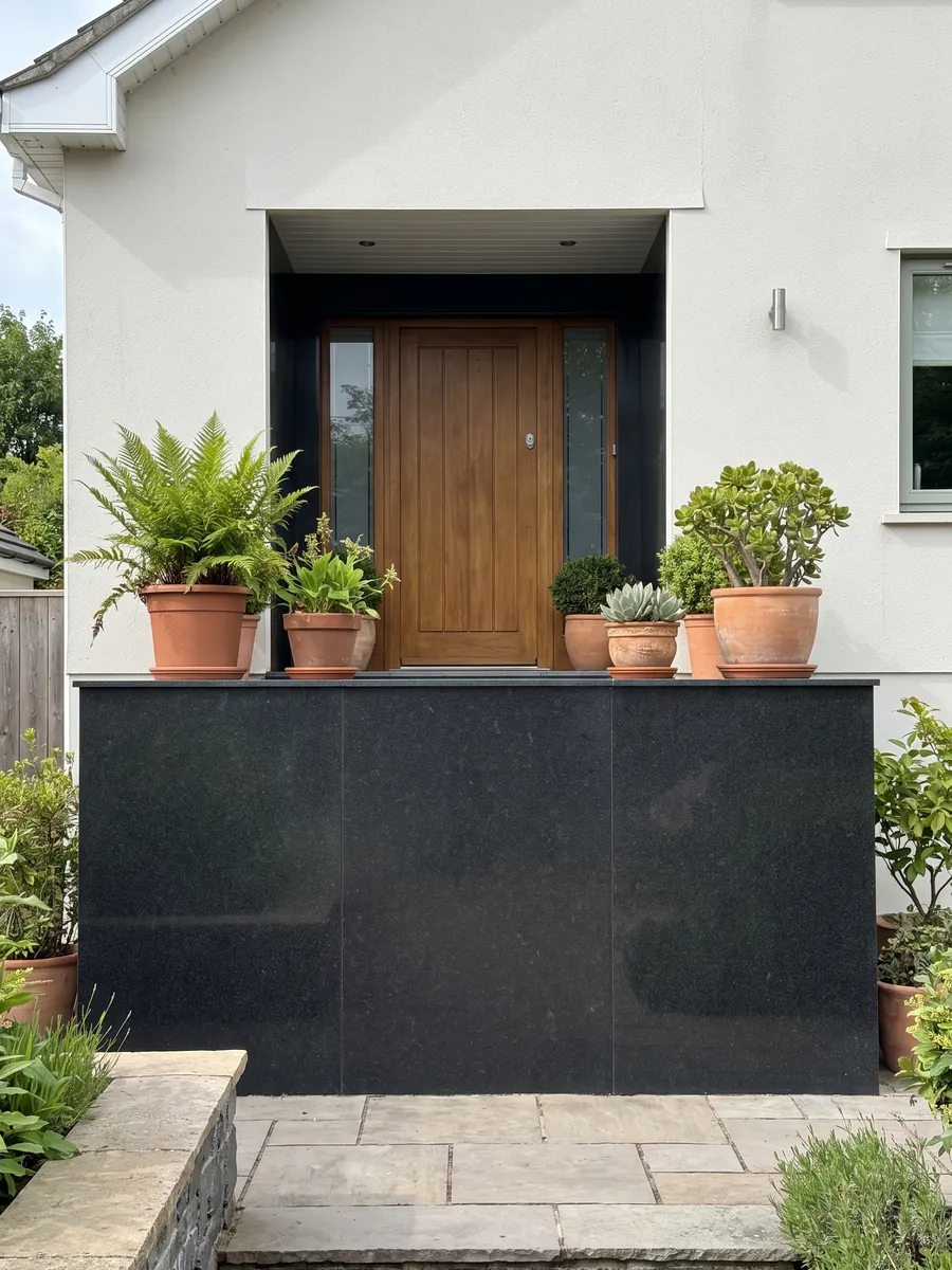 House facade clad in Titanium Black granite next to a wood door: an almost flat, uniform black with an extremely fine grain you only notice up close