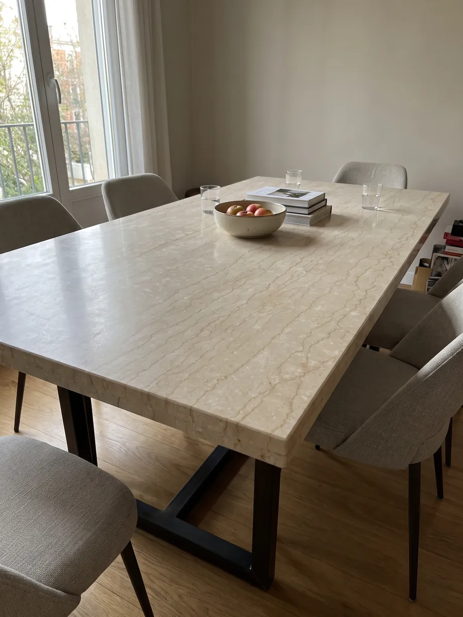 Dining table with a beige Botticino Classico marble top on a steel base: beige crossed horizontally by fine jagged light brown veins