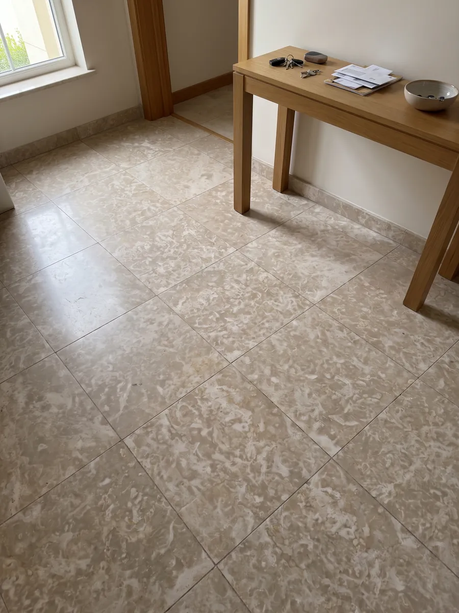 Entryway floor in large slabs of beige Botticino Fiorito marble with natural light: pinkish beige with scattered irregular light flower-shaped markings