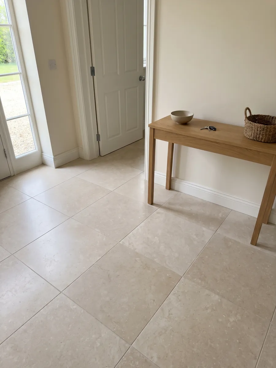 Entryway floor in large slabs of Botticino Light beige marble with natural light: very uniform light beige seen as a full slab