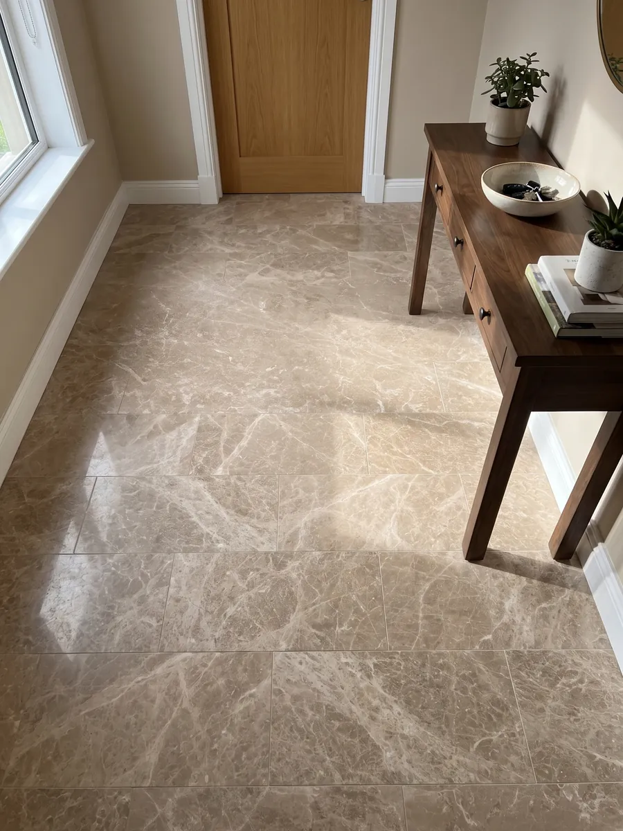 Entryway floor in large beige Monaco Light marble slabs with natural light: pinkish beige with a fine, even network of cream-colored veins