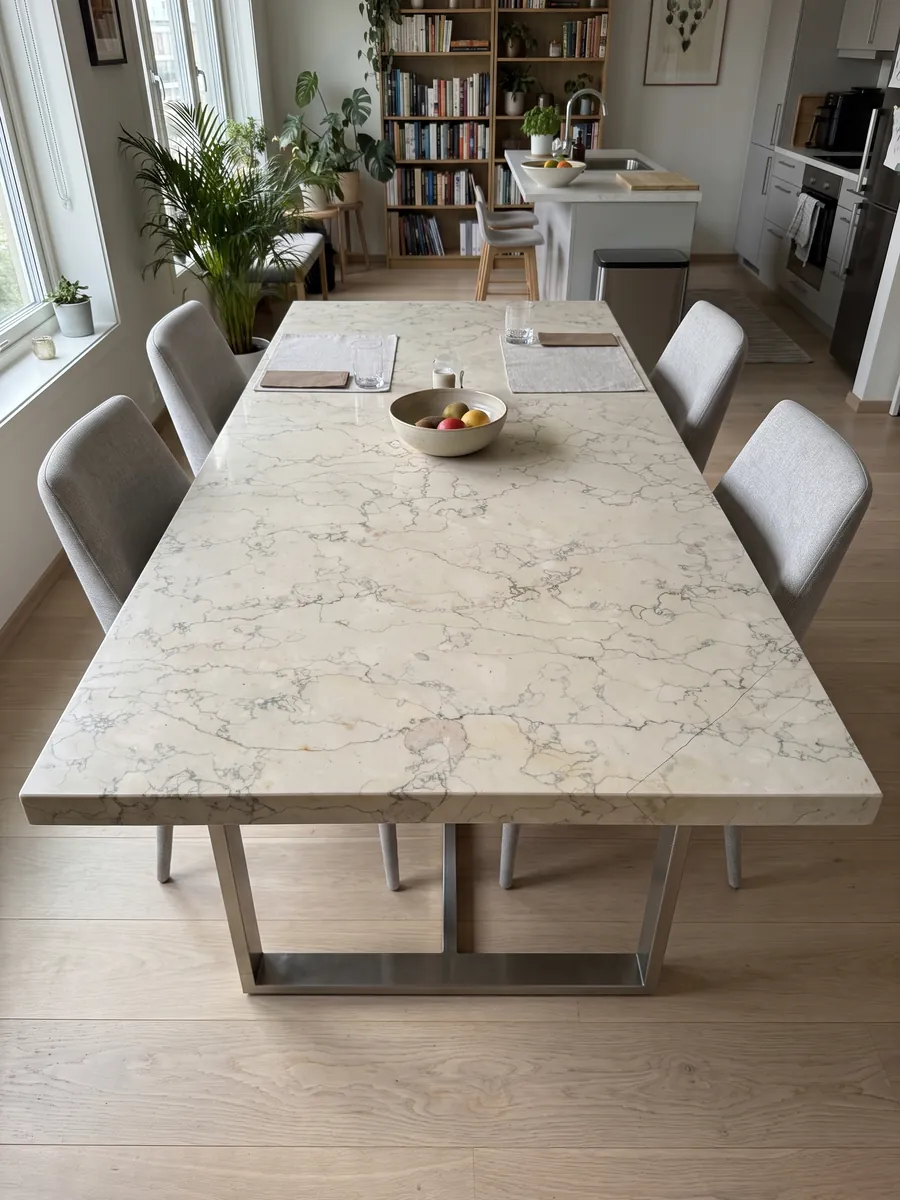 Dining table with a Verdello beige marble top on a steel base: beige background with a fine network of sinuous gray lines, like crackle