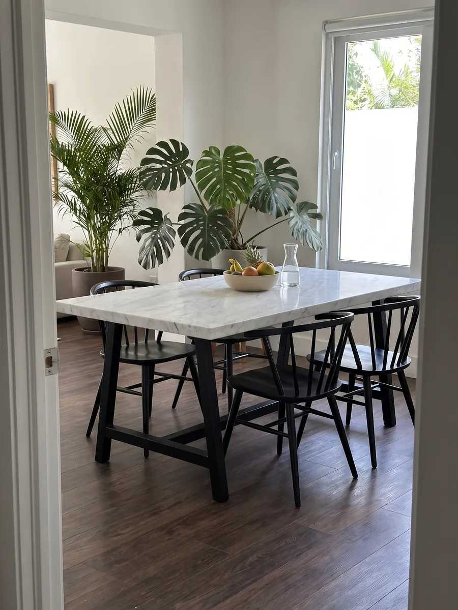 Dining table with a white Dolomite marble top on a steel base: grayish white with fine gray veins and the occasional darker line