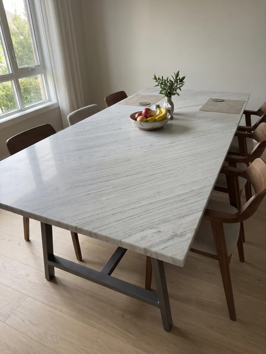 Dining table with a white Palissandro marble top on a steel base: grayish white with fine parallel gray strokes on the diagonal