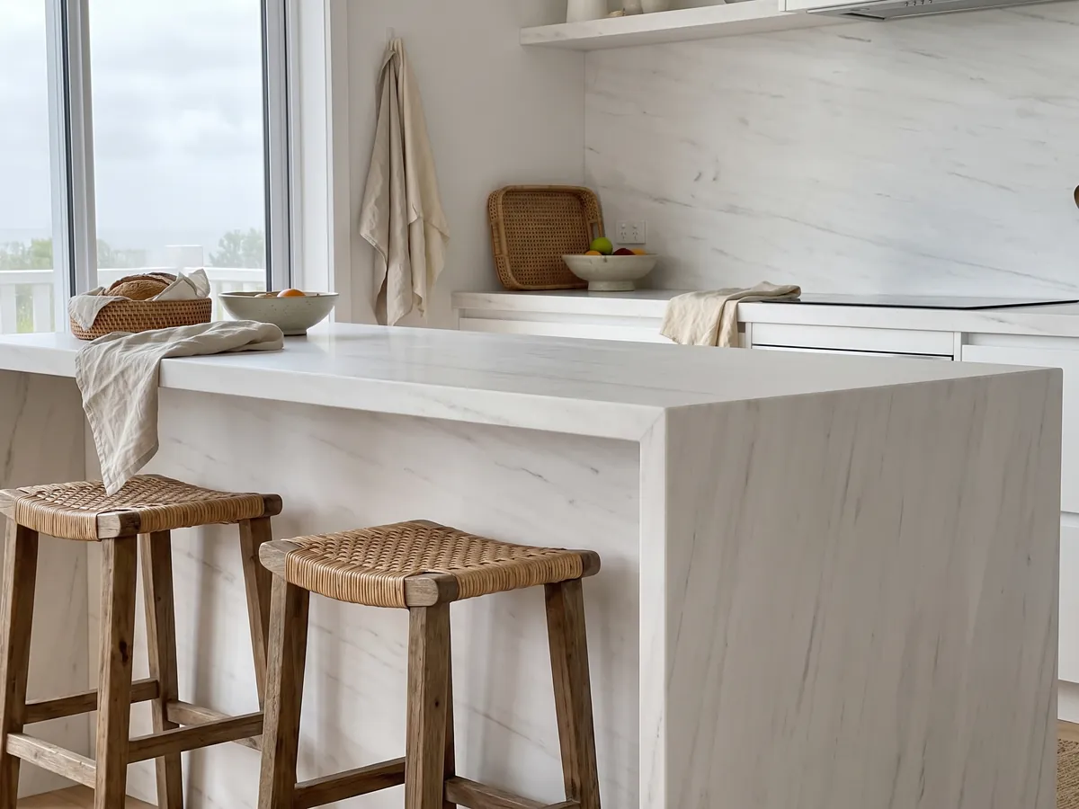Kitchen island with a white Snow White marble countertop and a straight edge in a naturally lit kitchen: a very clean white with barely visible gray strokes on the diagonal