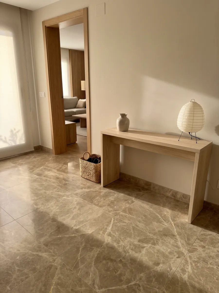 Entryway floor in large Emperador Light marble slabs with natural light: light brown with a fine web of cream veins