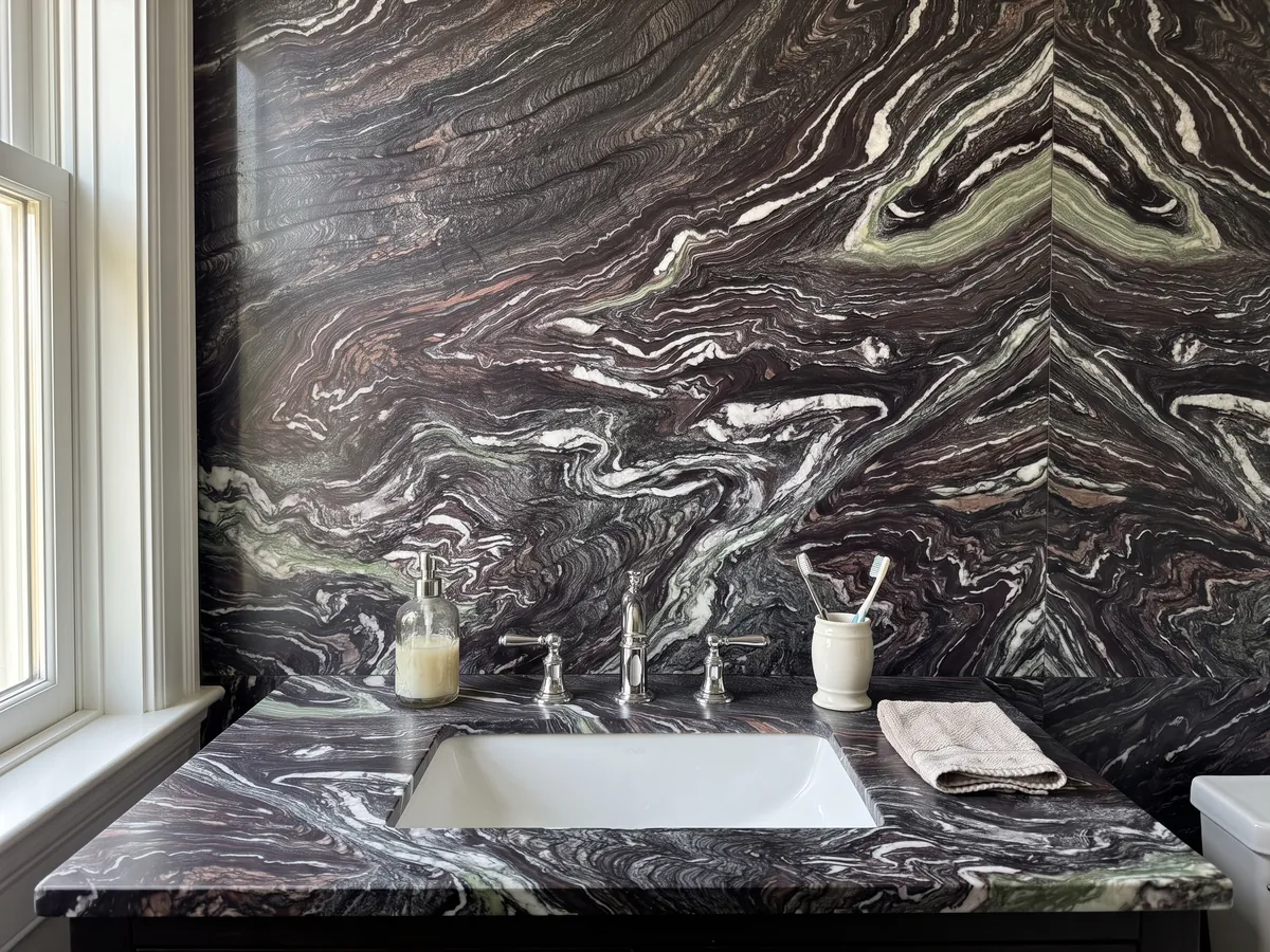 Vanity top and bathroom wall in Cipollino Ondulato Marble with a white sink and chrome faucets: deep purple background with strongly wavy, folded white veins