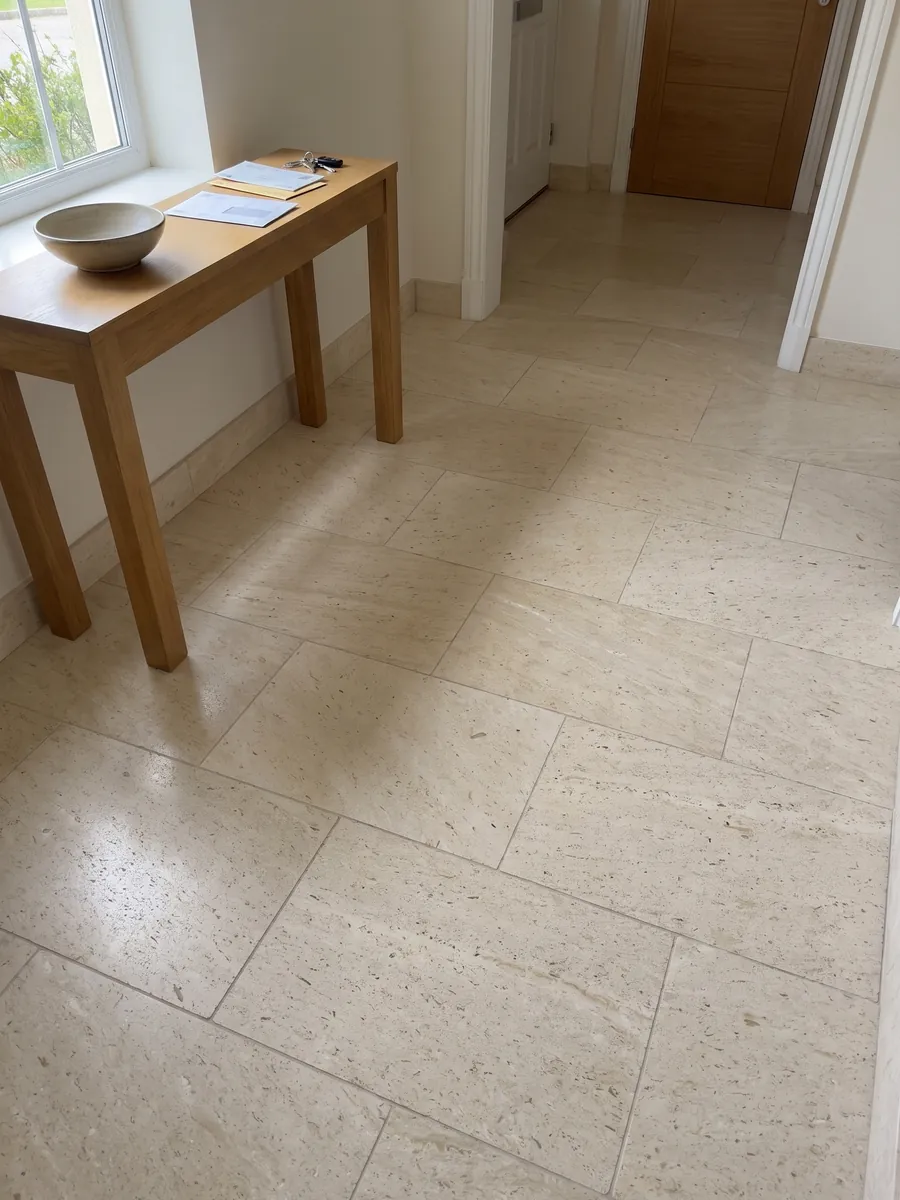 Entryway floor in large Fior di Crema marble slabs with natural light: a very even cream surface, fine grained, with no visible veins