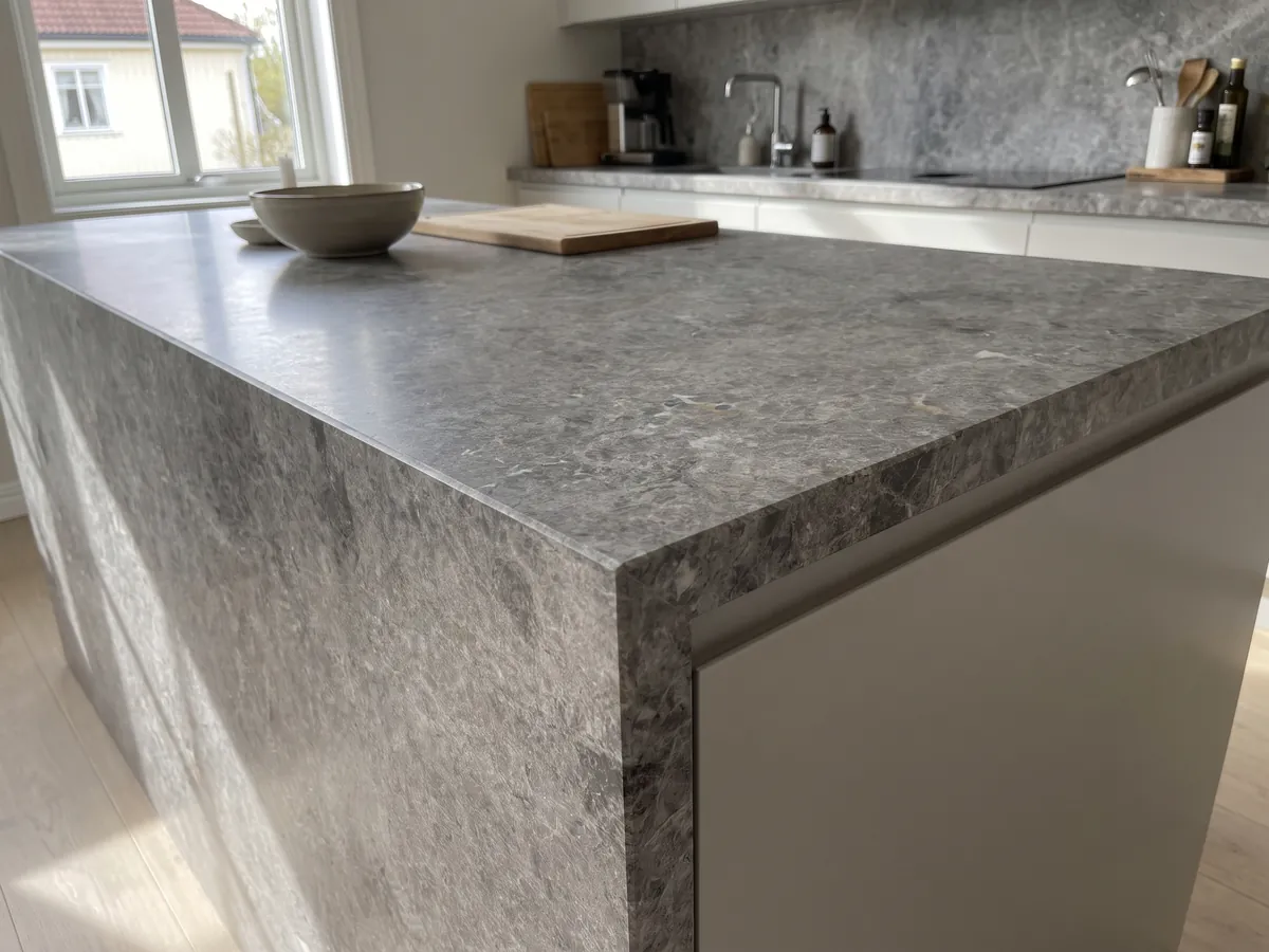 Kitchen island with a Tundra marble countertop and a straight edge in a kitchen with natural light: medium gray with darker clouds and a fine speckle of light dots
