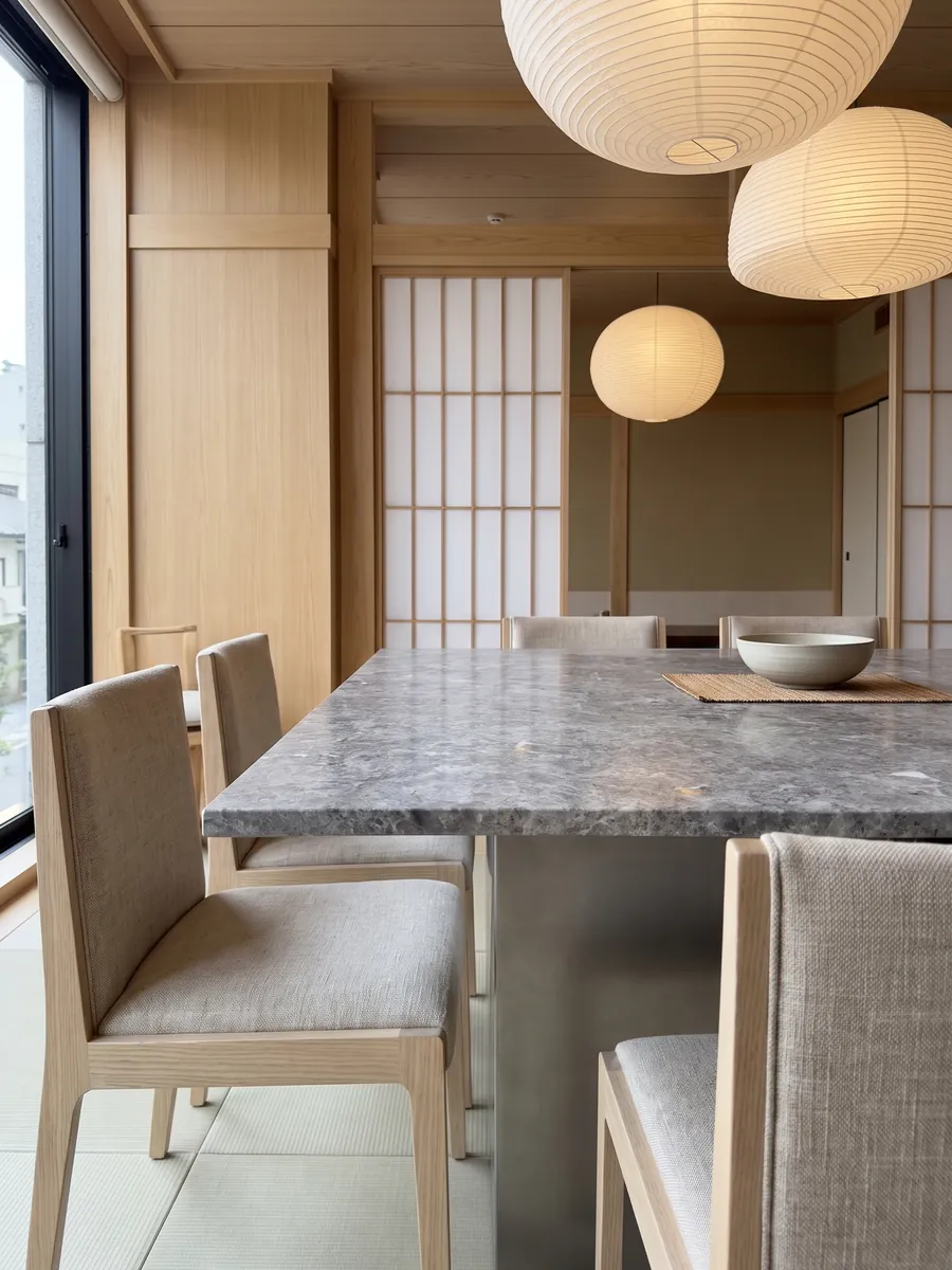 Dining table with a Tundra gray marble top on a steel base: medium gray with darker clouds and a fine speckling of light dots