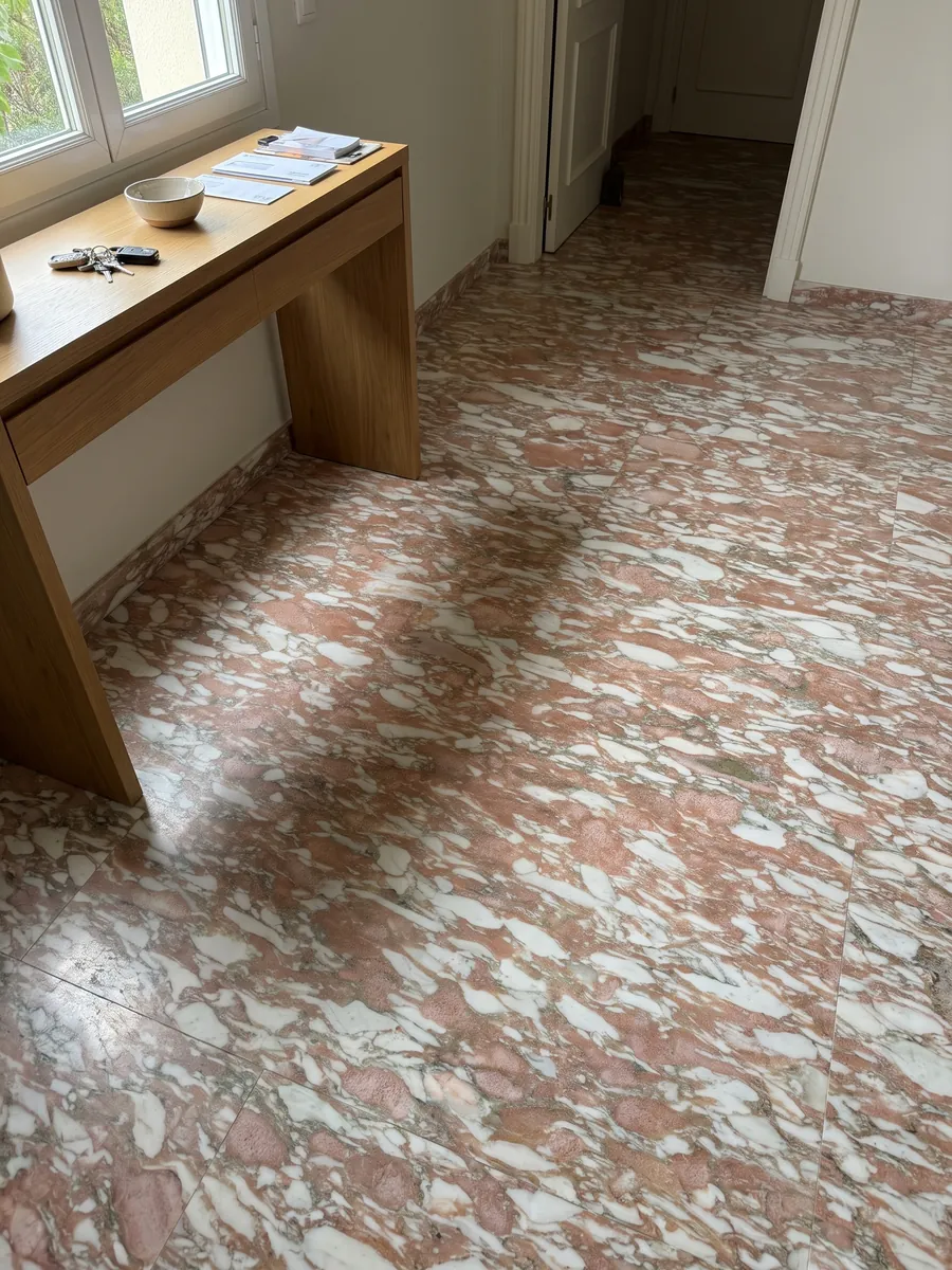 Entryway floor in large Rosa Norvegia marble slabs with natural light: salmon pink with long horizontal white strokes, like brushstrokes