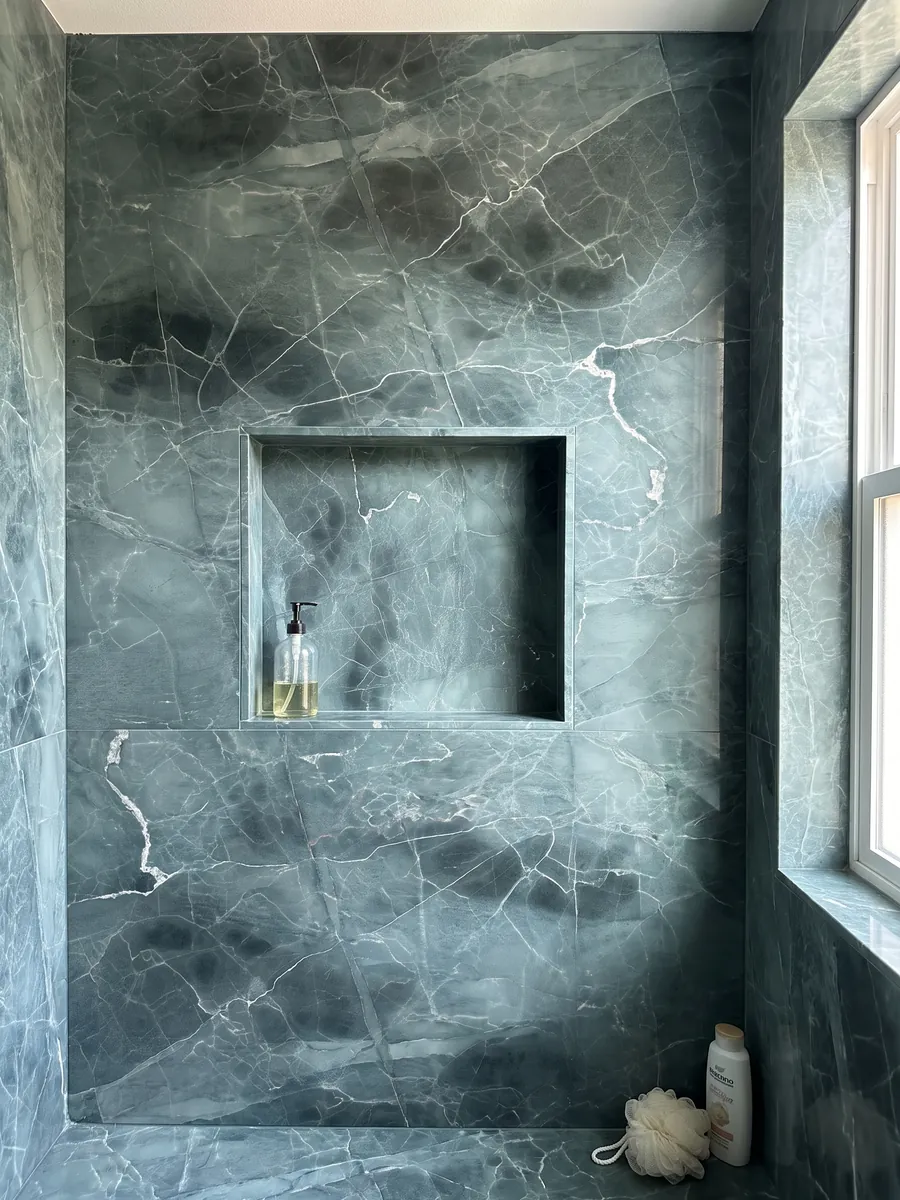 Shower clad in full slabs of Green Algae green marble with a recessed niche: teal with darker clouds and a network of fine white veins