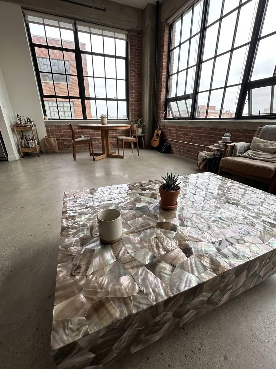 Coffee table with a Brown Shell Mother of Pearl top in a living room: pieces of taupe-gray and silvery mother of pearl with an iridescent sheen
