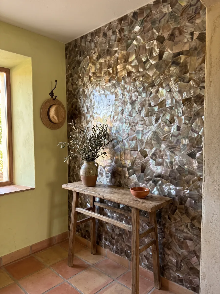 Entryway wall clad in Brown Shell Mother of Pearl with a narrow console: pieces of taupe-gray and silvery mother of pearl with an iridescent sheen