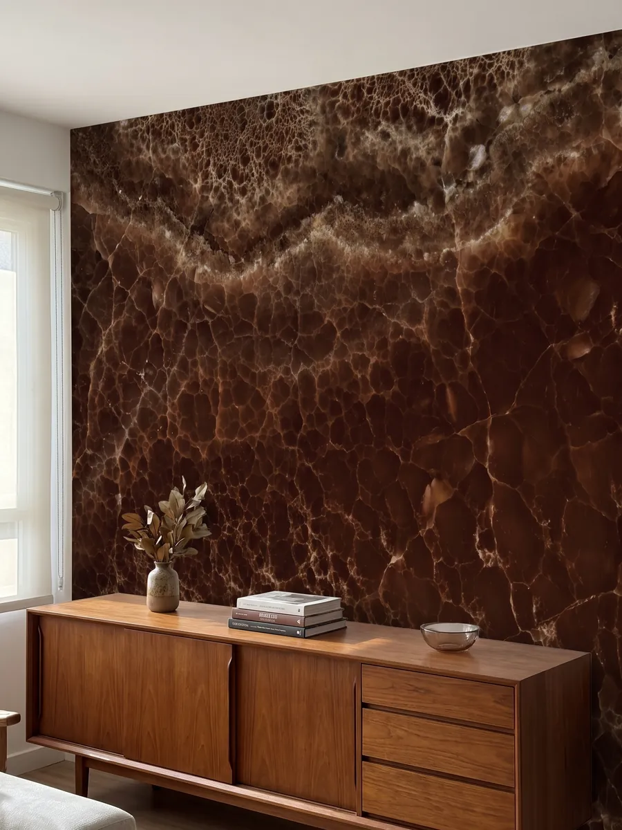 Accent wall clad in Brown Onyx above a low wooden cabinet: deep brown covered by a fine network of light lines and a bubbling band above
