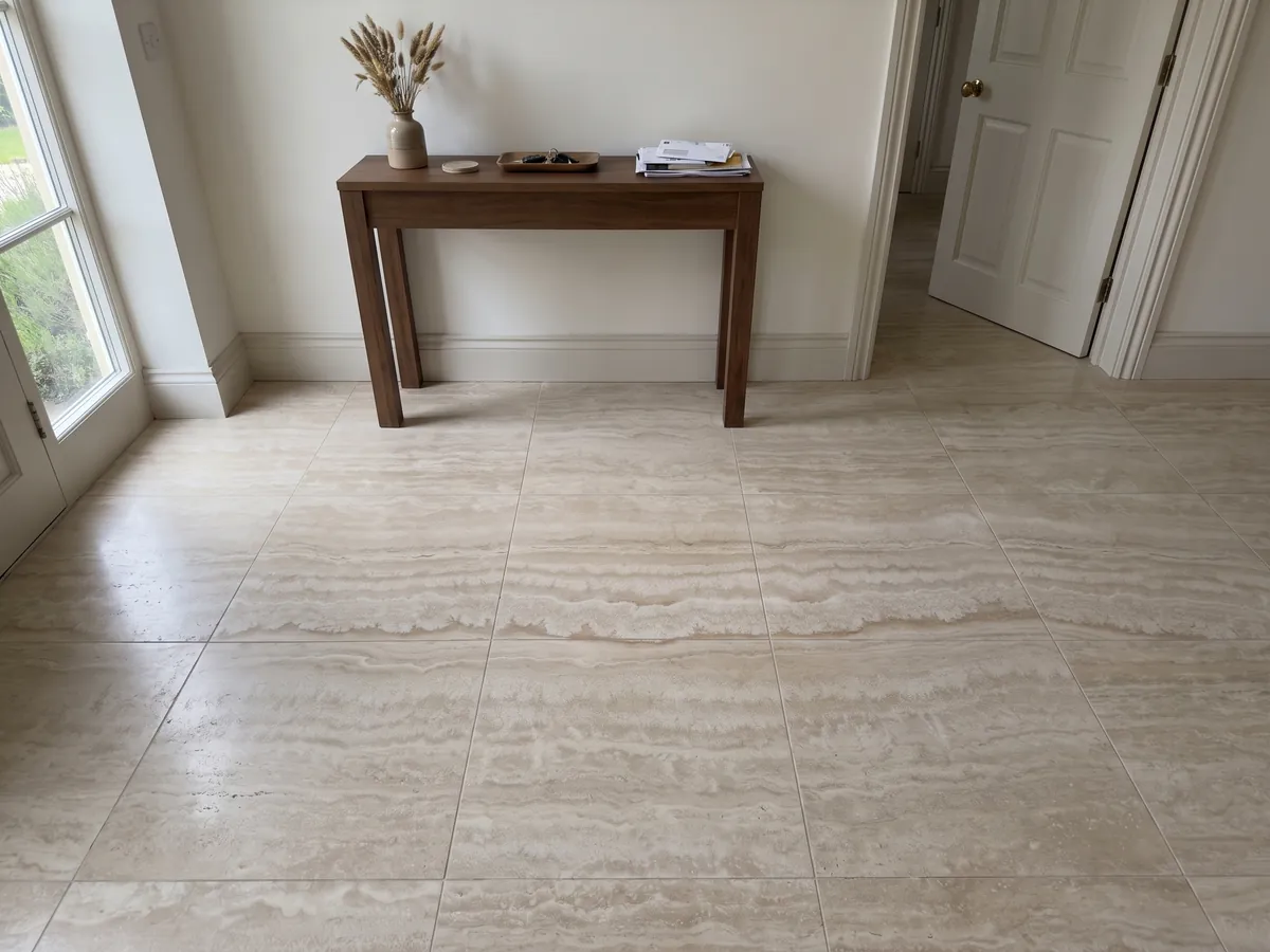 Entryway floor in large beige Paglierino travertine slabs with natural light: cream with wavy horizontal bands in very close tones