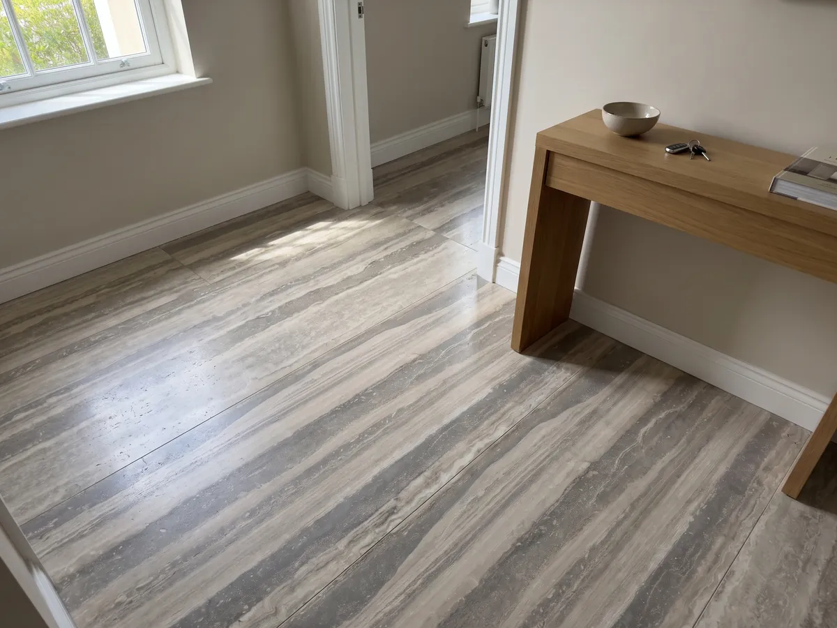 Entryway floor in large gray Silver travertine slabs with natural light: wide horizontal bands in gray and light beige, orderly and parallel