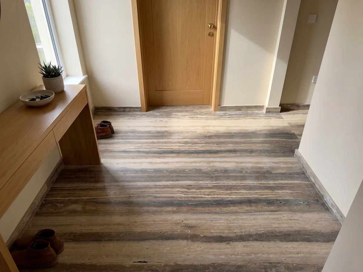 Entryway floor in large brown Dark Silver travertine slabs with natural light: bold brown and beige horizontal stripes along the slab