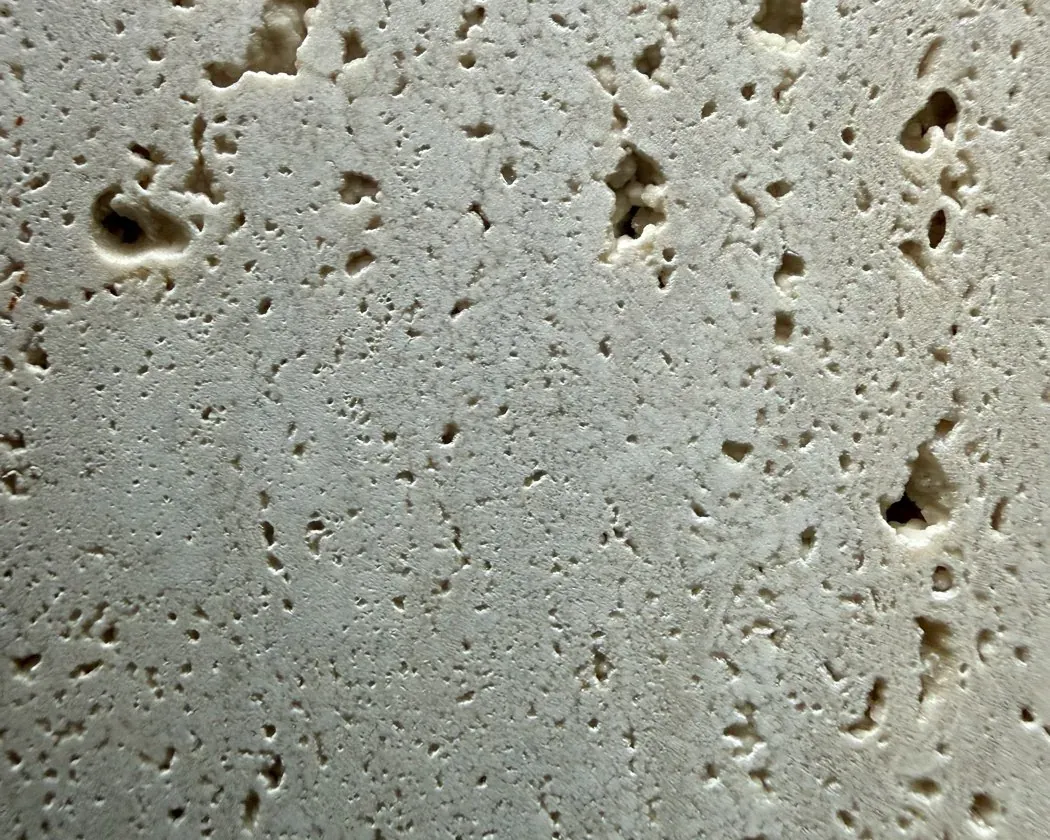 Classic Roman travertine slab in a warm beige, with the natural pores visible