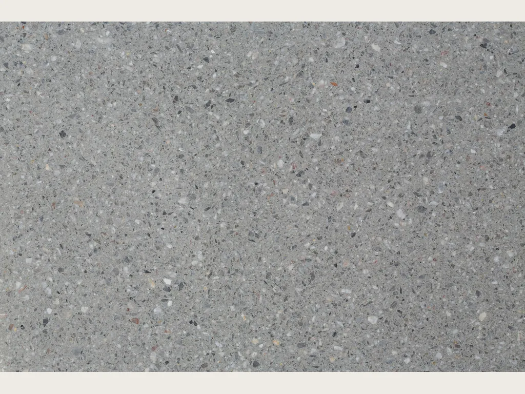 Slab of Fior di Pesco Grey engineered marble with cement: medium gray background with white and dark terrazzo-style fragments