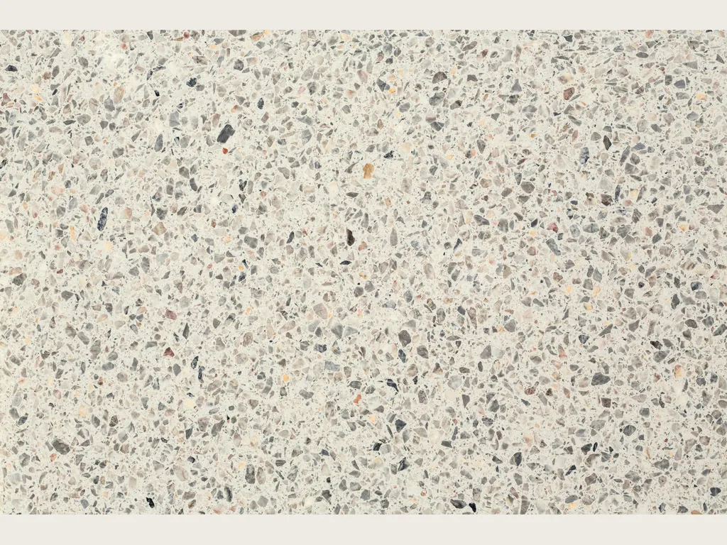 Slab of Fior di Pesco White engineered marble with resin: ivory background with gray and dark fragments, terrazzo style