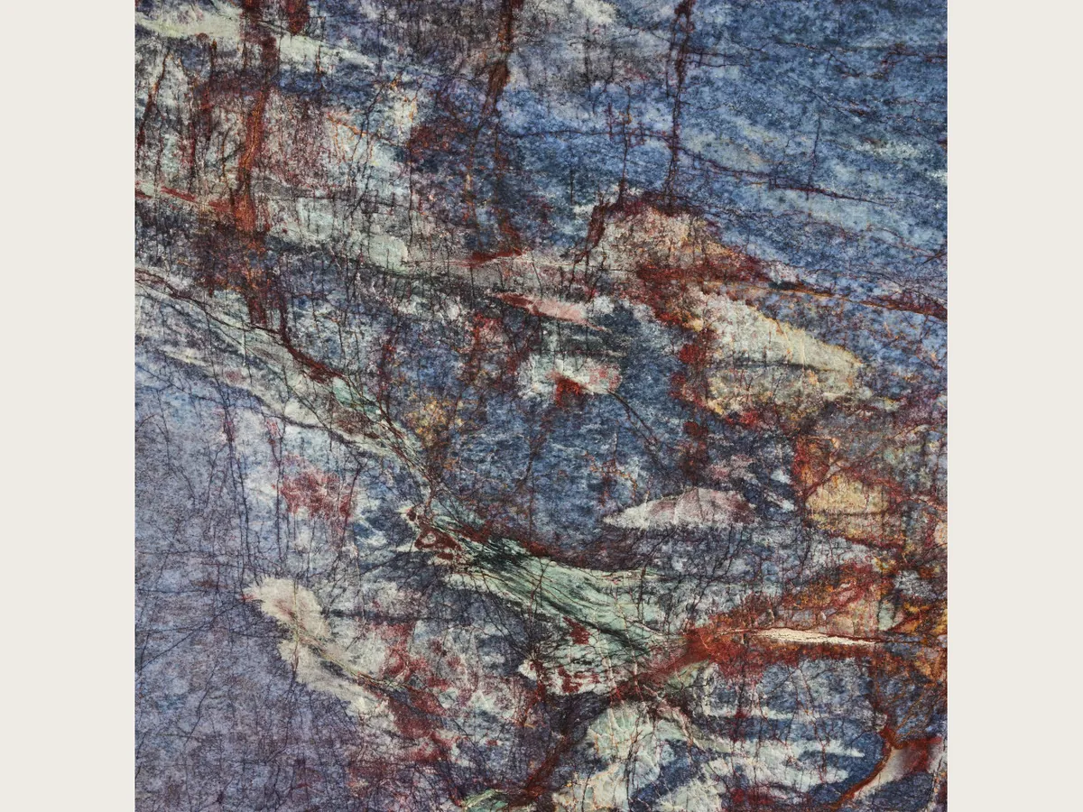 Blue Luise quartzite slab: violet blue background with a dense network of rust red veins and cream areas