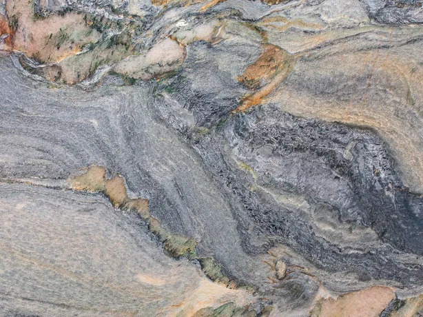 Close-up of blue Caravaggio quartzite: salmon and cream patches inside the blue-gray swirl