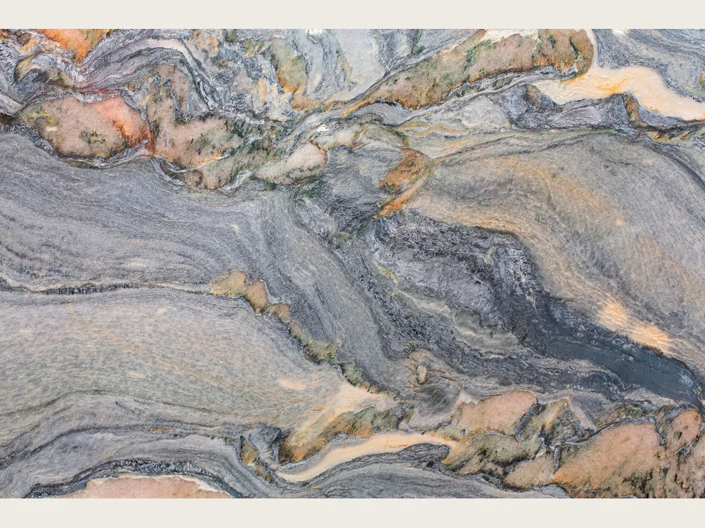 Slab of blue Caravaggio quartzite: diagonal blue-gray swirls with salmon and cream patches
