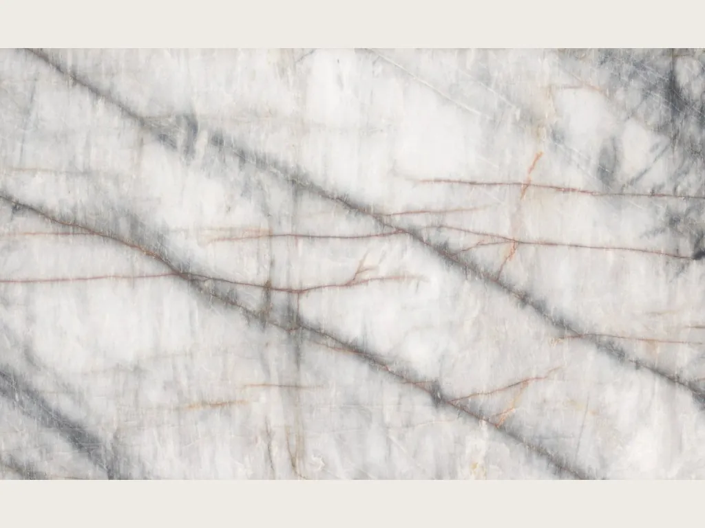 White Cristallo Black quartzite slab: white background with soft dark diagonal veins and thin orange lines