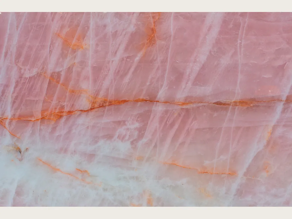 Cristallo Rosa quartzite slab: salmon pink with horizontal orange veins, diagonal white strokes and a bluish area below