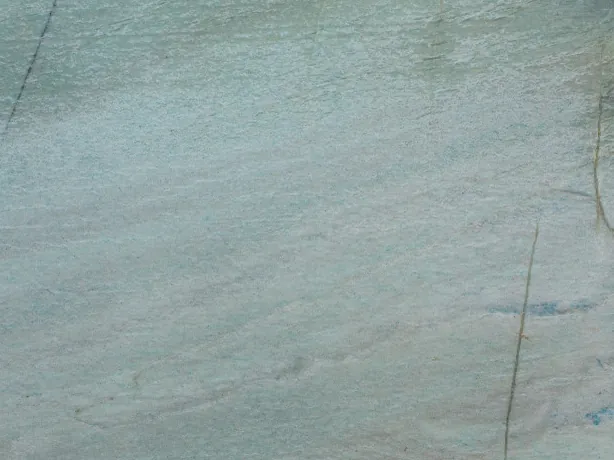 Detail of Emerald Green quartzite: soft diagonal streaks and blue glints over the polish